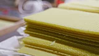 We use the one-year-old wax from the honeycombs to make our own foundation sheets
