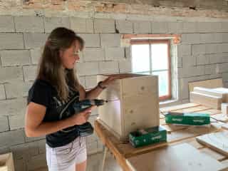 Romi doing carpentry on the new beehives