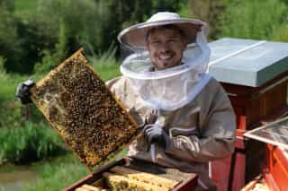 Portrait of Matthias working with the bees